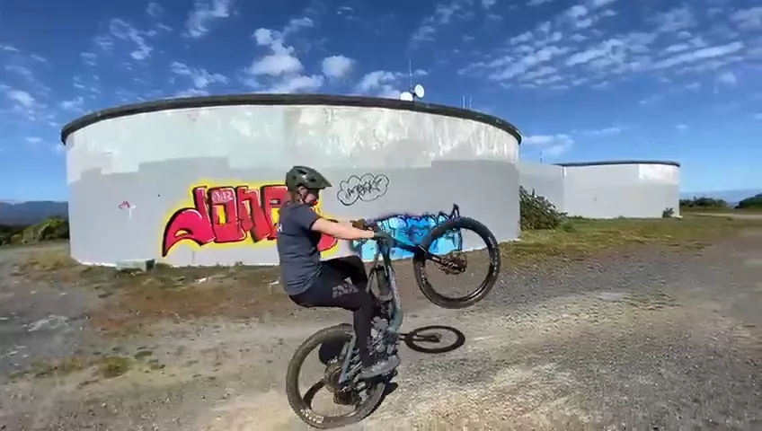 Nic Johnson Mountain Bike Coach demonstrating a wheelie